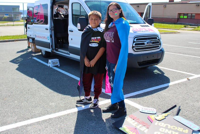 Eleven-year-old Allan Syllibo, left, and 16-year-old Jadis Paul wait for the start of the annual Pride parade in Eskasoni on Sept. 22 part of the fourth annual Kepmitelsi Eskasoni Pride week wrapped.