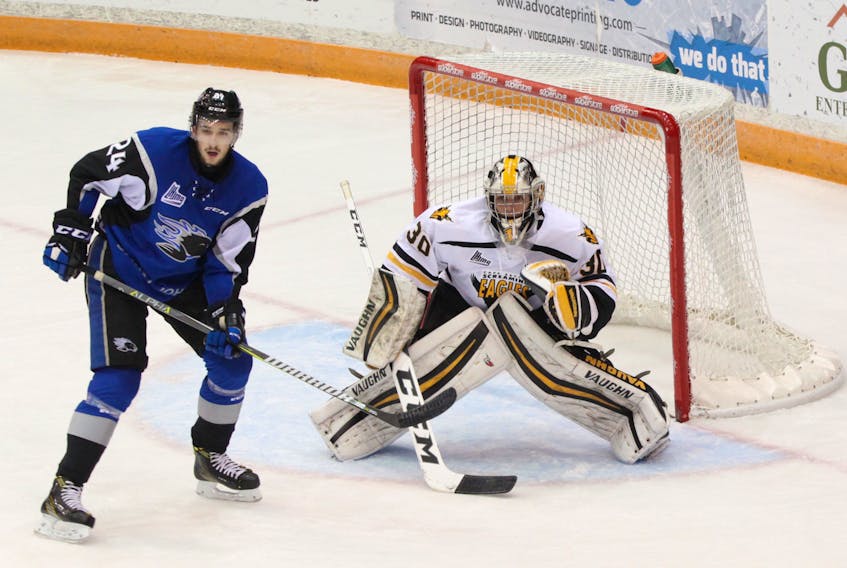 Screaming Eagles goalie Kyle Jessiman, shown here with the Sea Dogs’ Cedric Paré perched on the doorstep, was the winning goalie in Cape Breton’s road victory in Saint John on Sunday. The Eagles erased a three-goal, third-period deficit to force overtime during which Drake Batherson scored his third goal of the game to give Cape Breton a 6-5 win. (DAN CULBERSON/SAINT JOHN SEA DOGS)
