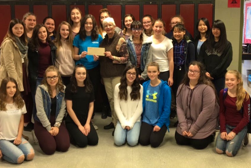 Members of the Me to We group at Glace Bay High School give a cheque for $700 to the Glace Bay Food Bank through money raised through various fundraisers. In front, from the left, are Marley MacLeod, Laurelle Caume, Abby Demeyere, Brennah Messervey, Isabelle Pilling, Katie Mills, and Jordan Reid. Second row, from the left, are Alexis Howley, Chelsey McKinnon, Kelsey McLean, Kaitlyn O’Neill, Sandra McPherson, co-coordinator of the Glace Bay Food Bank Shayndel Coombes, Lara Schafer, Kokoro Nagafuji, and Mashiro Saito. Third row, from left, are Brealee Hiscock, Alyssa Ward, Leah Hynes, Faith Somerton, Mackenzie Winters, Sarah McIntyre, Madison Capstick, and Mako Hasegawa. The group also recently donated $185 to three other local food banks and $1,000 to a Me to We international community in Tanzania. (Submitted photo/Glace Bay High School)