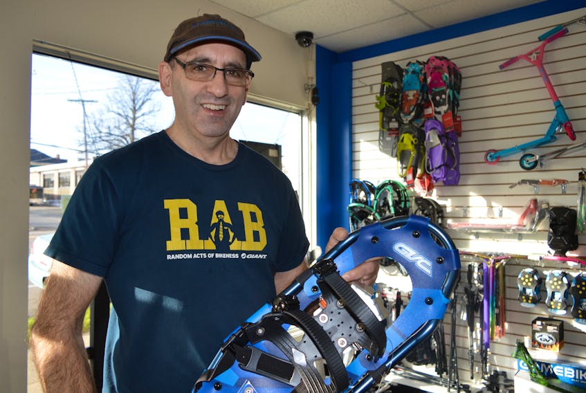 Bill Goldston, owner of FrameWork Cycle & Fitness on George Street in Sydney, holds one of the many lightweight snowshoes he has in stock. CHRIS SHANNON/CAPE BRETON POST
