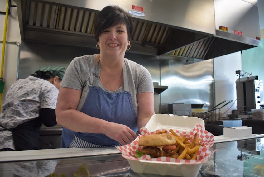 Kristen Kerr-Eagles, owner of Just In Thyme Homestyle Eatery in Sydney River, is shown just before serving up a chicken sandwich to one of her customers. The restaurant has been growing in popularity since opening in October.