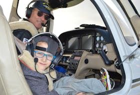 Brett Costigan, 7, of New Waterford sits excitedly as the co-pilot to businessman and pilot Dimitri Neonakis at the J.A. Douglas McCurdy Sydney Airport on Friday while preparing for a flight around Sydney that also included one of Brett’s brothers and a cousin.
