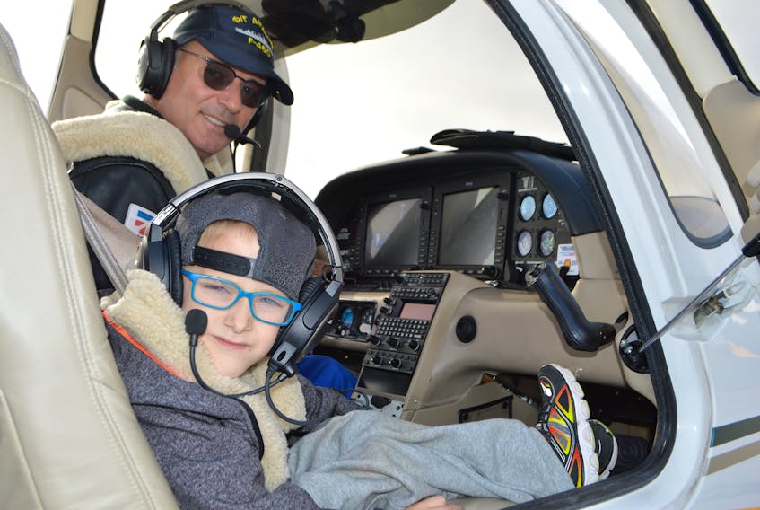 Brett Costigan, 7, of New Waterford sits excitedly as the co-pilot to businessman and pilot Dimitri Neonakis at the J.A. Douglas McCurdy Sydney Airport on Friday while preparing for a flight around Sydney that also included one of Brett’s brothers and a cousin.
