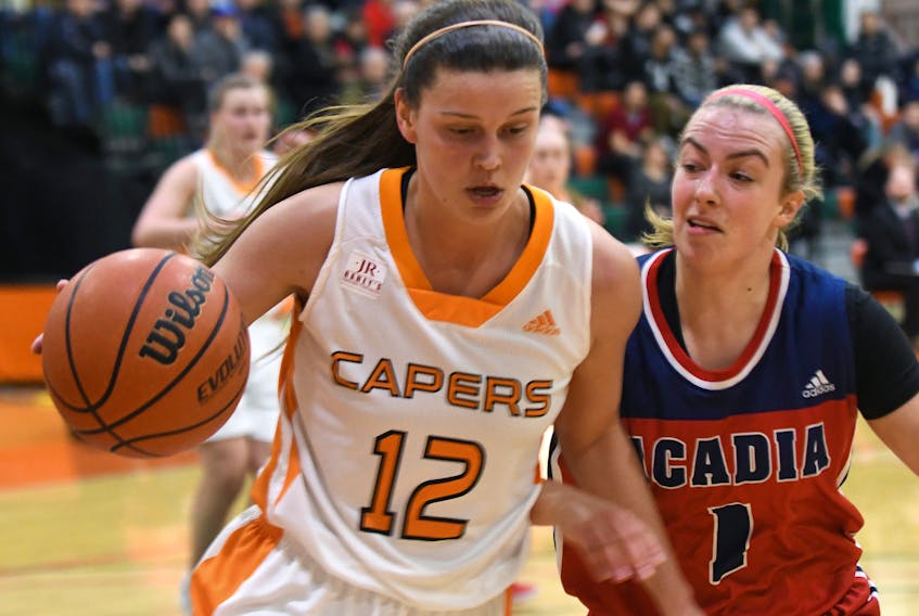 Alison Keough of Capers, left, and Ellen Hatt of Acadia go against each other in Atlantic University Sport basketball action at the Sullivan Fieldhouse at Cape Breton University, Friday evening.