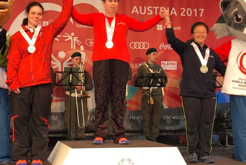 Aimee Gordon, centre, stands on the podium with Katharina Cramer, left, and Tzu-Yen Wu after receiving her gold medal at this year’s Special Olympics World Winter Games in Austria on Thursday.