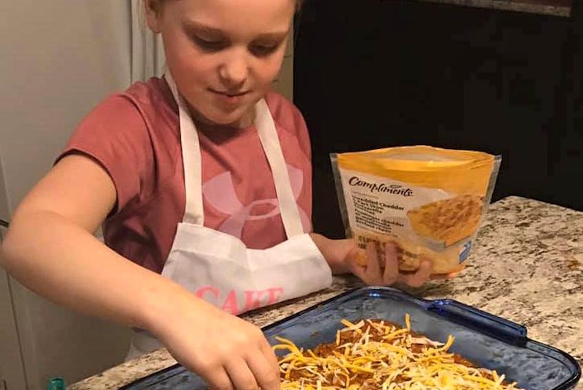 Sarah MacSween, 9, gets a lesson in how to make lasagna from her mother, June, earlier this week. The family has been staying put in their Marion Bridge home since March 15, as per recommendations by the Nova Scotia government to stop the spread of the highly contagious novel coronavirus which can lead to COVID-19. Cooking lessons are one of the activities Sarah is doing during her time away from friends, dance, swimming and school.