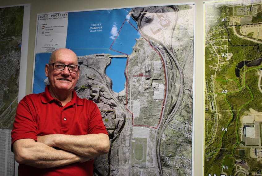 Membertou Chief Terry Paul stands next to a map of Sydney harbour with an outline of waterfront lands the Mi’kmaq community has acquired near Harbourside Commercial Park and is working to develop, including an in-filling project that will eventually make way for a wharf to serve fishing interests.