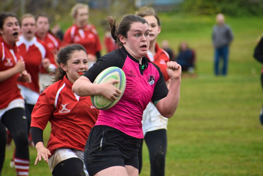 Makenna Norris of the Glace Bay Panthers, right, is chased by Kelsey Langlois of the Riverview Rugrats during the Highland Region girls rugby championship game Wednesday at Membertou Athletic Field. Norris broke free and charged down the field for a try in Glace Bay’s 33-0 victory.