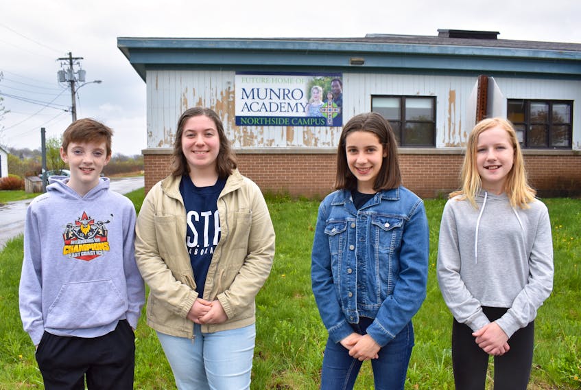 From left, Munro Academy students Rielly MacNeil, Katie Murphy, Naomi Barrett and Faith Jessome stand in front of the former St. Joseph’s Elementary School in Sydney Mines. Munro Academy recently purchased the building and will be using it as its Northside campus for Grades 5-12 starting in September.