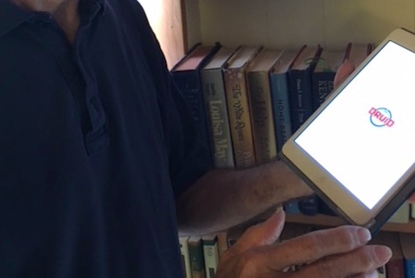 Michael Milburn, a professor of psychology at University of Massachusettes, holds an iPad that is uploading his Druid app. It is a self-assessment tool to help detect impairment from drugs and/or alcohol, that Milburn has been selling for more than a year.