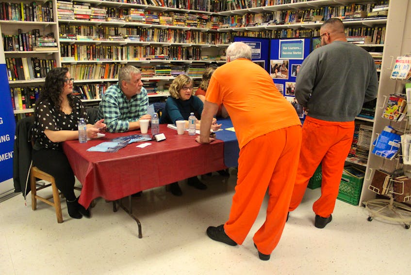 Representatives from Nova Scotia Works and the Adult Learning Association of Cape Breton County, seated, speak with two inmates on Wednesday during a community resource fair at the Cape Breton Correctional Facility. Part of an initiative to help inmates make connections with community and provincial organizations who can help them transition to life after time in jail, this is the second year the Nova Scotia Department of Justice has hosted fairs in each of the different correctional facilities.