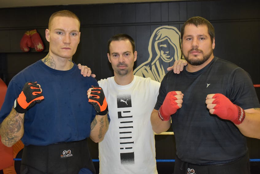 Ryan Rozicki of Sydney Forks, left, and Steve Whitall of Eskasoni, right, are shown with Thunder Boxing coach Glen Williams before a sparring session at the Sydney club this week. The two fighters were preparing for a pro boxing card on Saturday at Centre 200. T.J. Colello/Cape Breton Post