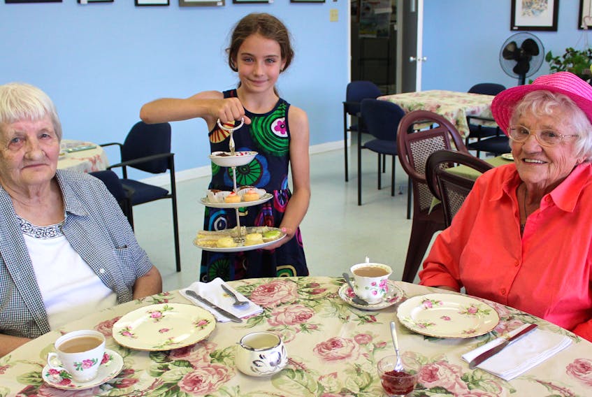 Esmée Lukachko, centre, serves to Mary Kennedy (left) and Jeanette Wadden at the Coastal Discovery Centre in Main-à-Dieu on July 24 during Tea By The Sea, which has been happening every Wednesday since the start of July. Cost is $5 per person and includes tea, sandwiches and sweets. Money raised goes toward programming at the centre. Lukachko, eight, lives in Toronto and is visiting Cape Breton for five-weeks. She helps her grandmother Pauline Mesher at the Coastal Discovery Centre when she can and is fluent in French and English. The last Tea By The Sea in Main-à-Dieu takes place on Aug. 28.