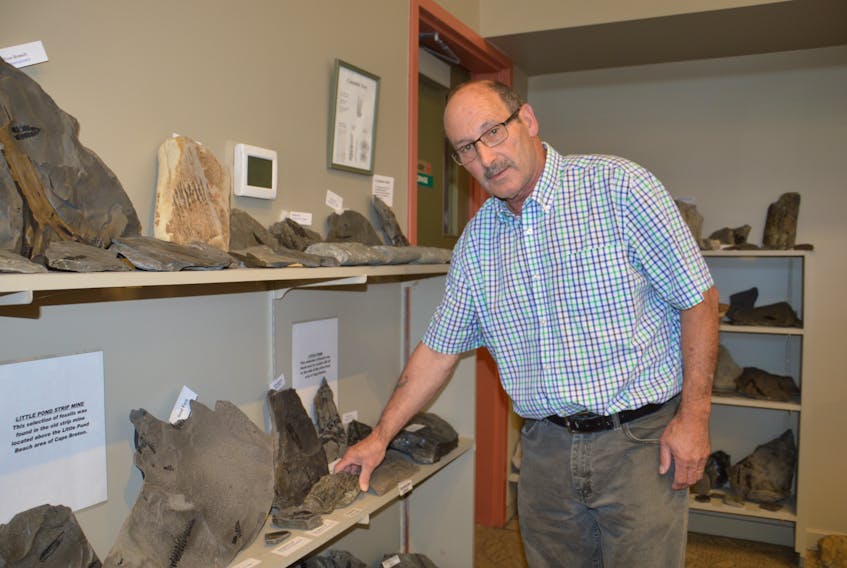 Stuart Critchley, curator for the Sydney Mines Heritage Society, shows fossils at the Cape Breton Fossil Centre in Sydney Mines. The Sydney Mines museums broke attendance records this year with more than 10,700 visitors attending the location. JEREMY FRASER/CAPE BRETON POST