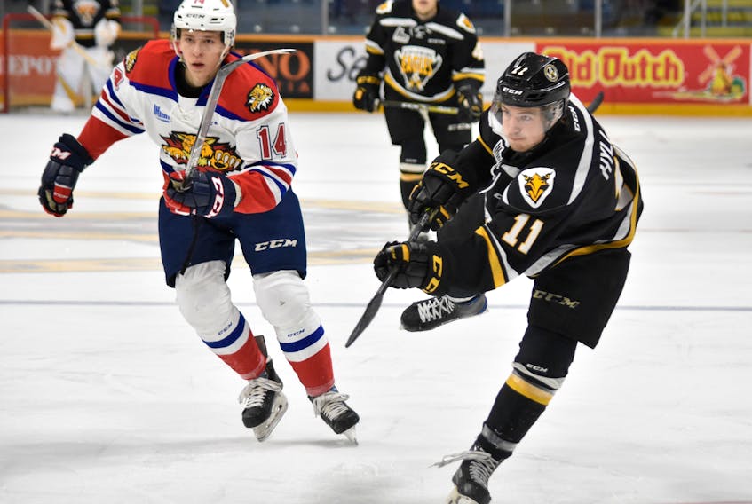 Tyler Hylland of the Cape Breton Screaming Eagles, right, fires a shot on goal while being watched by Jack Tucker of the Moncton Wildcats during Quebec Major Junior Hockey League action Tuesday at Centre 200.