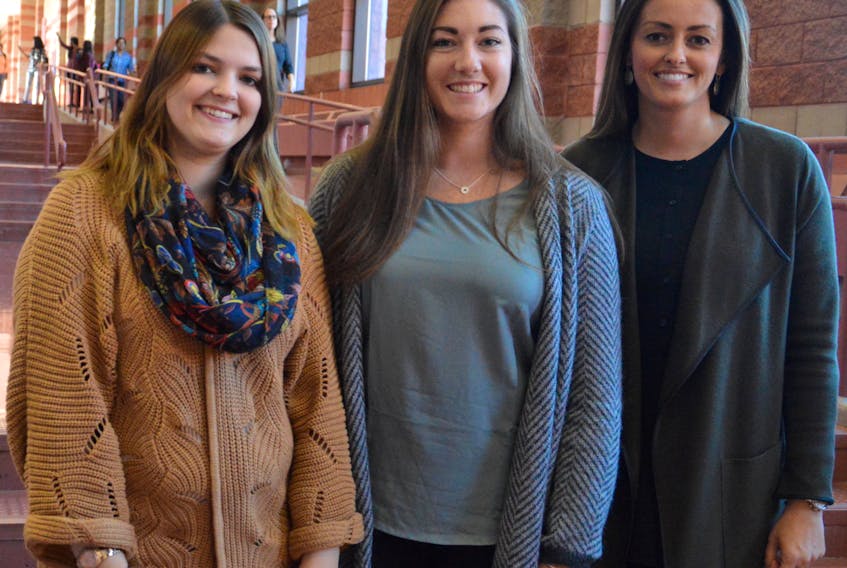 Cape Breton University bachelor of education students Victoria Clarke, from left, and Shauna Ryan stand with teacher Kristin O’Rourke, who is also the manager of the graduate programs in the education department.