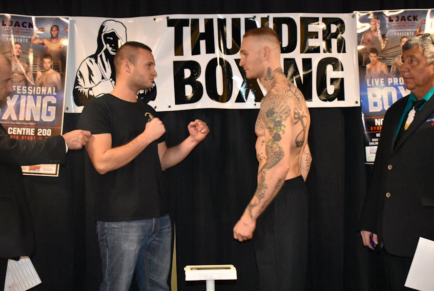 Kristof Demendi, left, from Slovakia, and Cape Breton boxer Ryan Rozicki are seen squaring off at boxing weigh-ins at Boston Pizza in Sydney on Friday evening. CHRISTIAN ROACH/CAPE BRETON POST
