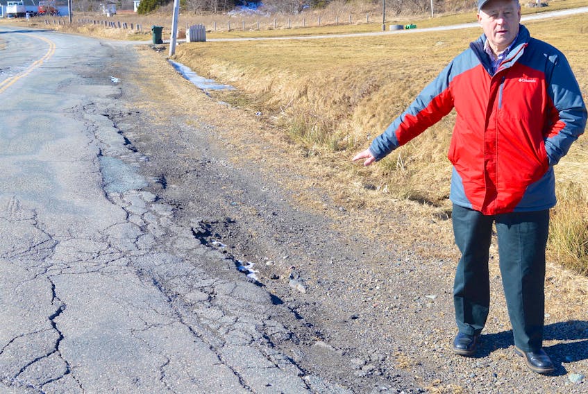 Ken Wadden of Main-a-Dieu shows a section of rough and broken pavement on the Main-a-Dieu Highway. He said the road throughout the Marconi Trail from Bateson to Louisbourg is in similar condition.