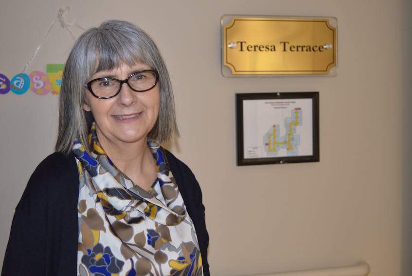 Glenda McKeough, co-chair of the fundraising committee for the Northside Community Guest Home, stands in front of the entrance of Teresa Terrace unit at the North Sydney facility. The fundraising committee will hold its annual spring gala and dance with money going toward renovations on Teresa Terrace.