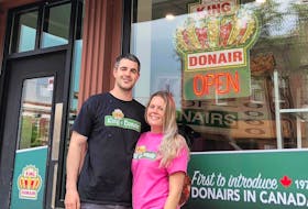 Colin Abbass and his partner Kayla Burke, both of Sydney, stand outside the King of Donair franchise they have opened on Whyte Avenue in Edmonton, Alta. It’s the first permanent foray for the Halifax-based donair and pizza chain into Western Canada.