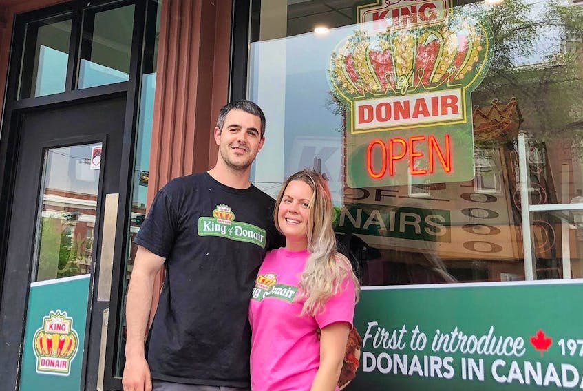 Colin Abbass and his partner Kayla Burke, both of Sydney, stand outside the King of Donair franchise they have opened on Whyte Avenue in Edmonton, Alta. It’s the first permanent foray for the Halifax-based donair and pizza chain into Western Canada.