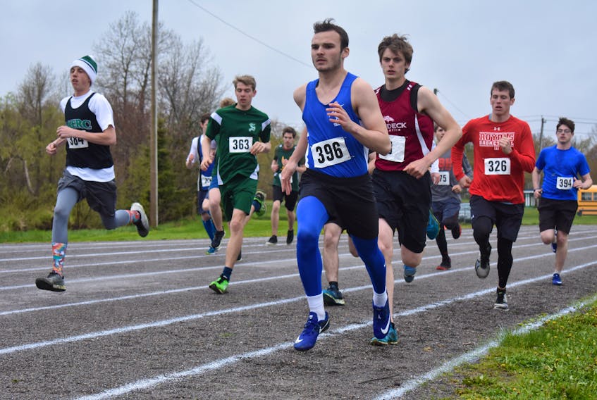 Brandon Martin of Sydney Academy, wearing bib number 396, leads the pack while at right Chance Blackstone of Baddeck Academy and Ethan Merlin of Riverview High School follow close behind during the 1,500-meter senior boys run during the Highland Region track and field championships at Atlantic Field in Sydney. Martin went on to win the race with a time of 4:47.72. Blackstone finished second with a time of 5:01.57. The events conclude Saturday.