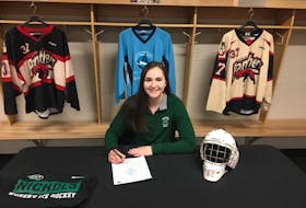 MacIntyre Chevy Panthers goaltender Julia Carroll is shown signing recruitment papers to attend Nichols College in Dudley, Mass. The graduating goaltender is expected to battle for the NCAA team’s starting job. PHOTO SUBMITTED/PAUL CARROLL