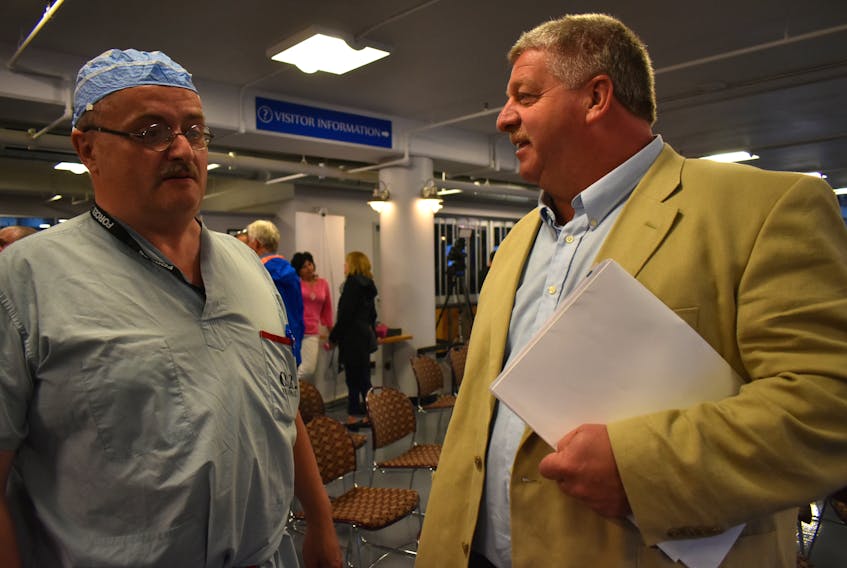Northside-Westmount MLA Eddie Orrell, right, talks to Dr. Craig Stone, staff anesthesiologist for all hospitals in the CBRM, after the Liberal government’s health care announcement on Monday. Both have concerns about the plan which includes closing two hospitals, building two long-term care facilities and expanding the Cape Breton Regional and Glace Bay Hospitals.