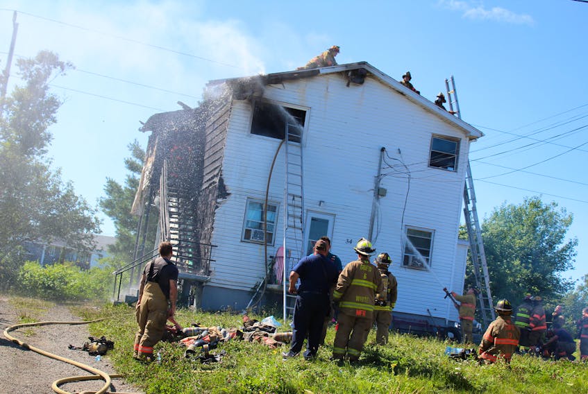Firefighters from Glace Bay and Reserve Mines department battle a structure fire in Glace Bay on Aug. 25. All residents of the three-apartment complex have been displaced and one woman was taken to hospital after escaping the blaze by jumping out a second-storey window.