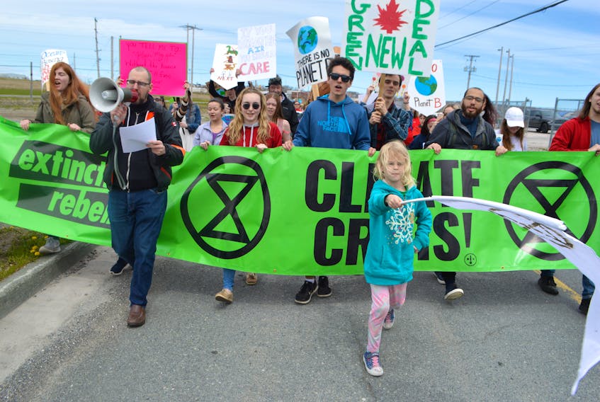 Scott Sharplin, co-ordinator of the Cape Breton branch of Extinction Rebellion, is accompanied by his daughter Pastel Sharplin, 7, while leading the March for the Earth from the Open Hearth Park in Sydney to the civic centre on May 24, 2019. Cape Breton’s Extinction Rebellion group will hold a rally today at the civic centre from 12-3 p.m.