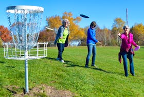 First-time participants Patricia MacNeil, Katherine MacDonald and Janice Bates practice their ‘putting’ while enjoying the splendid autumn weather as they made their way around the CBRM’s new ‘nine-hole’ disc golf course at Rotary Park in Sydney. Instead of holes, the course features metal and chain baskets into which players attempt to land their discs. DAVID JALA/CAPE BRETON POST