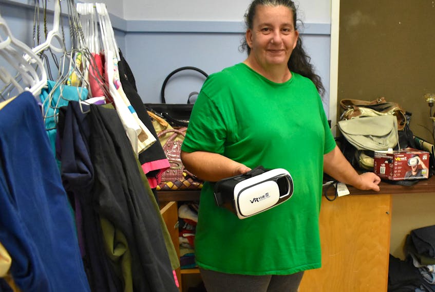 Jeannette MacDonald, a member of the Glace Bay Y's Men's and Y's Women's Club, sets up used clothing, furniture and household goods for a depot the organization is opening at the Morrison Campus. The goal is to help low-income families in the area as well as raise money for a new furnace needed in the building.