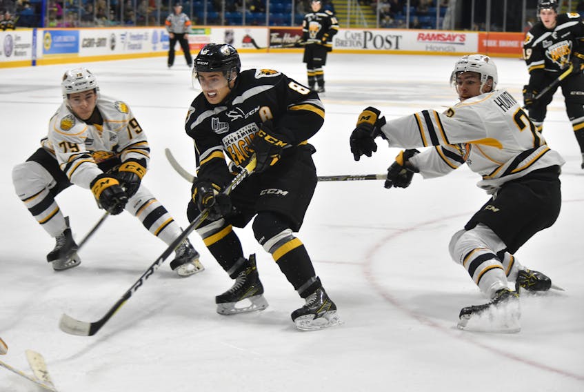 Phélix Martineau of the Cape Breton Screaming Eagles, middle, drives to the net with Benjamin Thibeault, left, and Jimmy Huntington of the Victoriaville Tigres trying to stop him on Thursday at Centre 200. The Eagles edged the Tigres, 3-2. T.J. Colello/Cape Breton Post