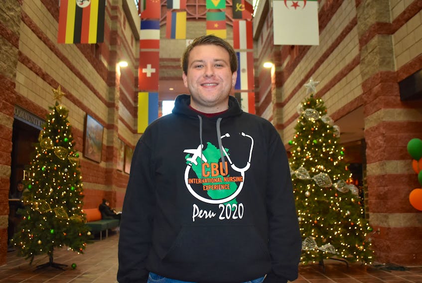 Austin Chapman stands in the Great Hall in Cape Breton University’s Student, Culture and Heritage Centre. The third-year nursing student, who was recently voted the Cape Breton Regional Chamber of Commerce CBRM Citizen of the Year, is travelling to Peru with 25 other nursing students to help people in the South American country.