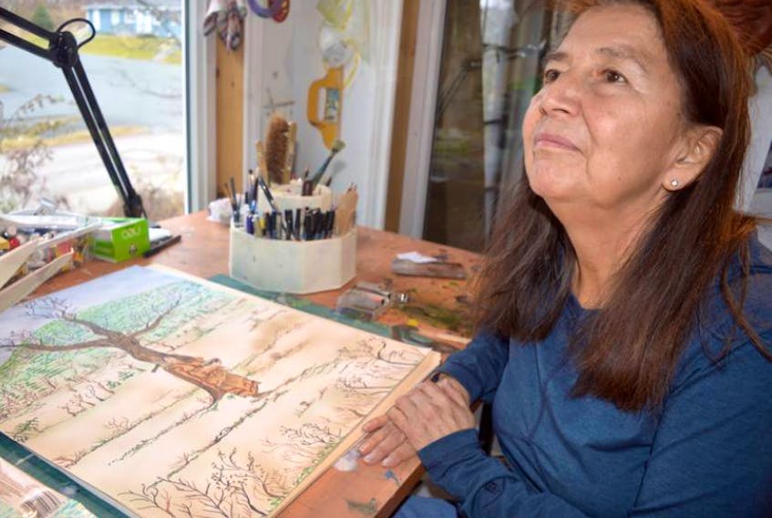 Arlene (Dozay) Christmas is shown with some of the preliminary sketches that she does before working on a painting. Christmas passed away Thursday, Nov. 21, at the age of 65.