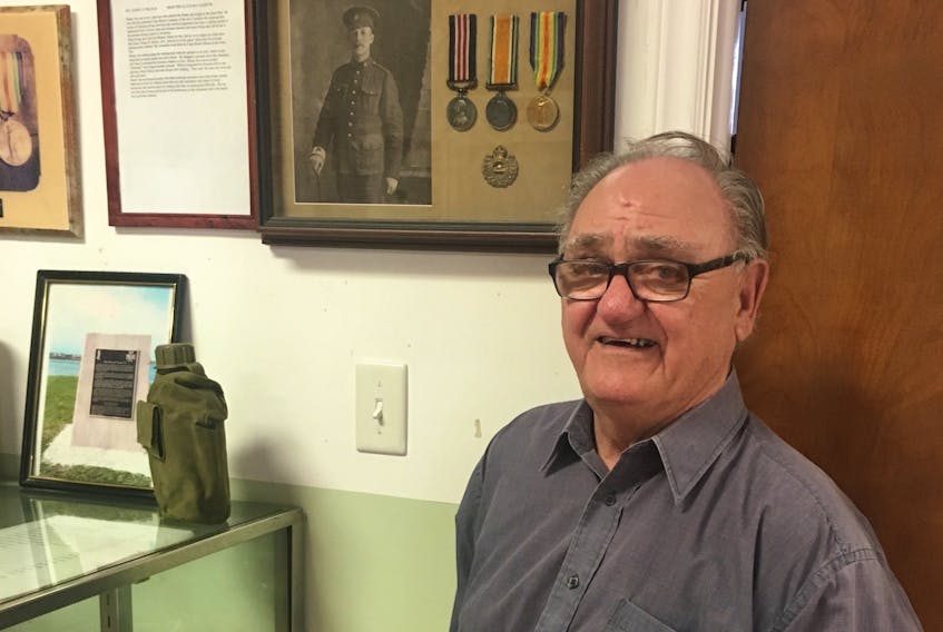 Shelly MacNeil stands in front of a picture of his grandfather at Royal Canadian Legion branch 3 in Glace Bay. MacNeil’s grandfather fought in the First World War.