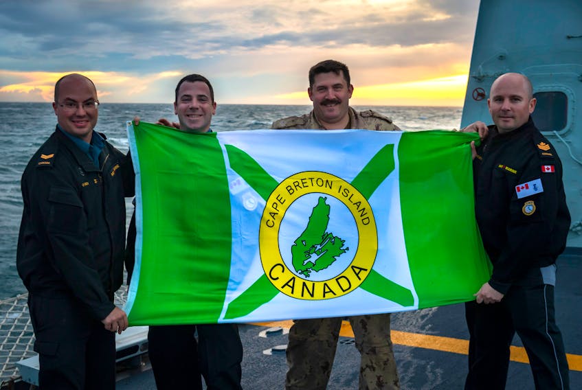 Four Cape Bretoners proudly hold the island's flag aboard the HMCS Halifax while deployed on Operation Reassurance (a NATO initiative) in the Mediterranean Sea. The four spent Christmas on the ship during their six-month deployment, which started in July. From left are Leading Seaman Matthew O'Brien, Cpl. Patrick McLeod, Master Cpl. William Robert King and Petty Officer Second Class Craig MacLean.