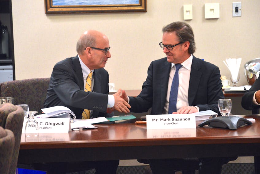 Cape Breton University president David Dingwall shakes the hand of board of governors vice-president Mark Shannon following Friday’s approval of a $57.3-million operating budget.