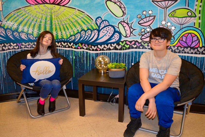 Emma Smith-MacPherson, left, and Zane Pinhorn are two of the young artists who created this artwork at Whitney Pier Memorial Middle School. The mural is in a room just outside the school’s guidance offices, offering students a safe place to go when things aren’t going right for them.