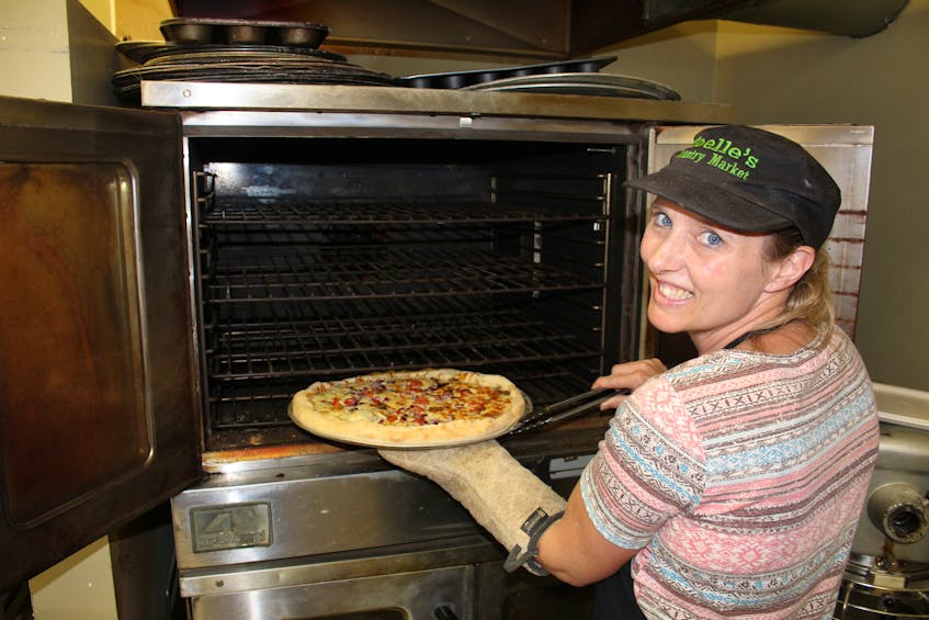 Noelle Christie, owner of Noelle’s Country Market, in Balls Creek checks on a freshly baked pizza on Thursday morning. Pizzas are a popular lunchtime treat at the market, as are hot dogs and fresh baked goods. Christie said people stop by from all over Cape Breton for her baked goods and she always looks forward to seeing new faces. The market also has a convenience store and gas station and employs four people. It’s open Monday-Friday from 7 a.m. until 10 p.m. and Saturday and Sunday from 8 a.m. until 10 p.m.