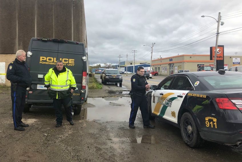 Cape Breton Regional Police are shown at the scene of the former Canada Post building on Dodd Street in Sydney on Tuesday.