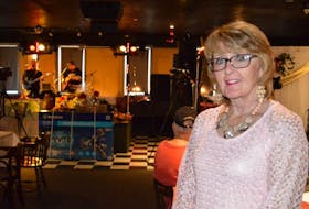 Shelly McLellan stands in front of the stage at New Waterford's Rack N Roll Billiards during Saturday's Combined Christmas Giving event.