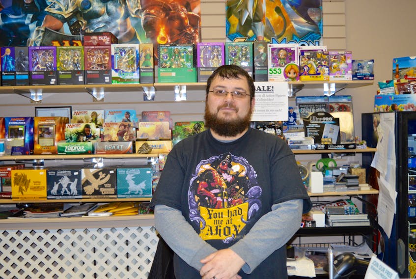Ed Mah, owner of The Local NPC Games and Comics shop, stands behind the counter of the gaming store that is located at the corner of Charlotte and Prince streets in Sydney. DAVID JALA/CAPE BRETON POST