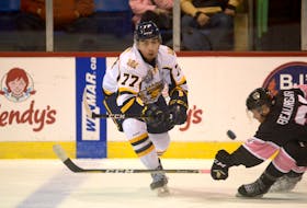 Leon Denny of the Shawinigan Cataractes, left, attempts to make a pass during a Quebec Major Junior Hockey League game against the Charlottetown Islanders last season. The Eskasoni defenceman will return to Cape Breton Thursday when the Cataractes play the Cape Breton Eagles at Centre 200 in Sydney.