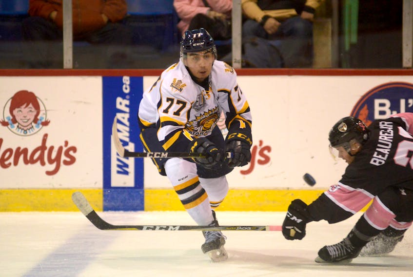 Leon Denny of the Shawinigan Cataractes, left, attempts to make a pass during a Quebec Major Junior Hockey League game against the Charlottetown Islanders last season. The Eskasoni defenceman will return to Cape Breton Thursday when the Cataractes play the Cape Breton Eagles at Centre 200 in Sydney.