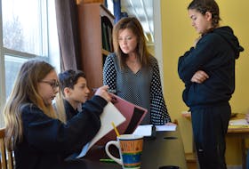 Michelle Morrison, second from right, founder and principal of Harbourside Montessori School, works with three middle school students at the school, from left, Amy MacAdam, Manny Strong and Neela Virick.