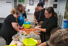 A group of people prep the ingredients for the recipe they are doing at a Slow Cooked Dreams workshop held at the Whitney Pier Boys and Girls Club in January. From left to right, going around the table, are Gloria Kehoe, Hannah Lynk, Stella MacPherson, Darren Huntington, Callum MacPherson and Rayanne Rogers.