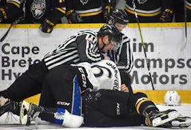 Linesmen Dave Ivey, right, and Stephen Clarke break up a fight during recent Quebec Major Junior Hockey League action at Centre 200 in Sydney. The league was expected to vote on banning fighting during its February presidents and owners meeting, however the vote was postponed until August.