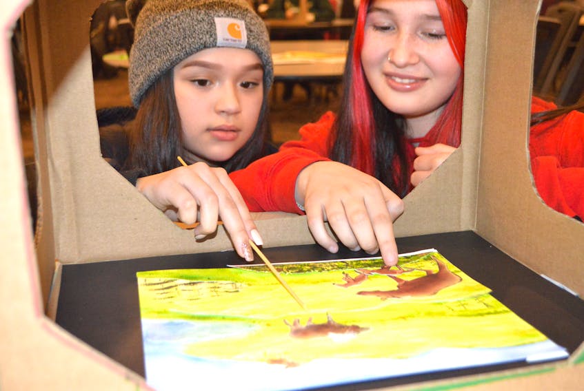 Callie Stevens, left, and Kelsey Johnson, Grade 7 students of Eskasoni Elementary School, work on a stop-motion animation project at the Membertou Trade and Convention Centre Friday. The students were among 200 First Nations students from across Cape Breton working on the project using illustrations by artist Dozay Christmas from a five-book series of traditional Mi’kmaq animal stories by authors with Unama'ki Institute of Natural Resources. The digital project will see the Mi’kmaq books brought to life in five films.