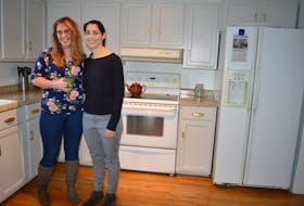 From left, Chelsea Fenton and Laura Whyte stand in the kitchen of the newly renovated farmhouse in Point Edward that is home to the Hope Project. Nikki Sullivan/Cape Breton Post